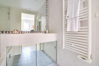 a bathroom with a sink and a mirror at Parc RL Perfect 1 bedroom apartment next to beaches and shops in Cannes