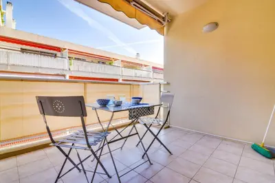 a small balcony with a table and two chairs at Parc RL Perfect 1 bedroom apartment next to beaches and shops in Cannes