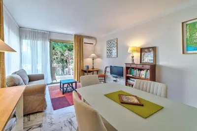 a living room with a dining table and a living room at Appartement le San Francisco bright and calm 3 bedroom flat in Cannes