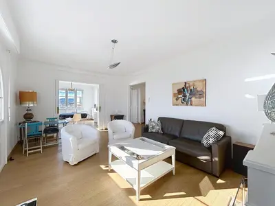 a living room with a couch and a table at Palais Alexandre III Magnificent 4 sea view 100m from the Croisette in Cannes