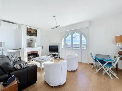 a living room with a couch and a table at Palais Alexandre III Magnificent 4 sea view 100m from the Croisette in Cannes