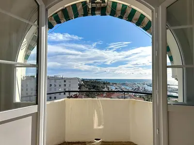 a window view of the city from a balcony at Palais Alexandre III Magnificent 4 sea view 100m from the Croisette in Cannes