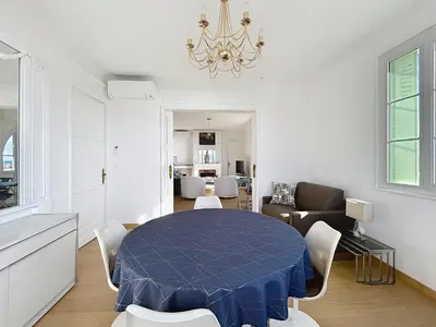 a dining room with a blue table and chairs at Palais Alexandre III Magnificent 4 sea view 100m from the Croisette in Cannes