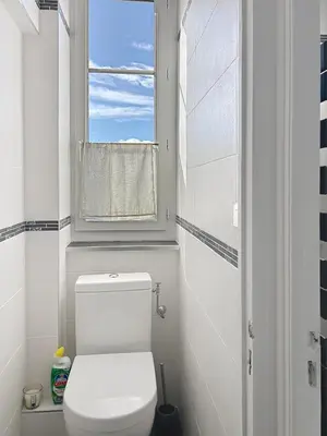 a bathroom with a white toilet and a window at Palais Alexandre III Magnificent 4 sea view 100m from the Croisette in Cannes