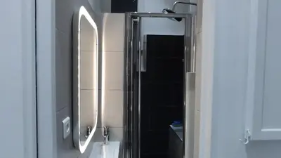 a bathroom with a shower with a mirror and a sink at Le QG - CANNES - Palais du Festival in Cannes