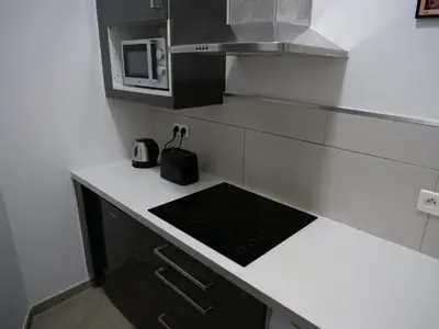 a kitchen with a stove and a microwave at Le QG - CANNES - Palais du Festival in Cannes