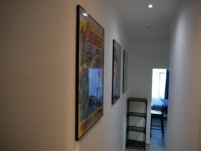 a hallway with three framed pictures on a wall at Le QG - CANNES - Palais du Festival in Cannes