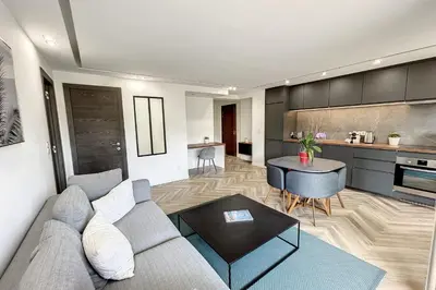 a living room with a couch and a table at Heart of Cannes contemporary 2BR garden view Palais & Croisette 5 mn by Olam Properties in Cannes