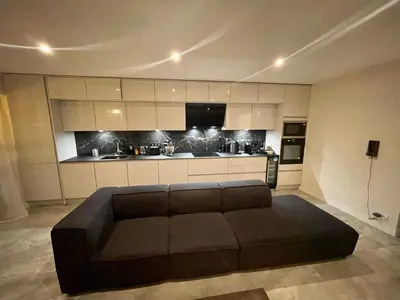 a living room with a brown couch in a kitchen at Cannes Centre ville in Cannes