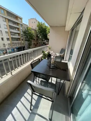 a balcony with a table and chairs on it at Cannes Centre ville in Cannes