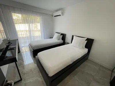 two beds in a small room with a window at Cannes Centre ville in Cannes