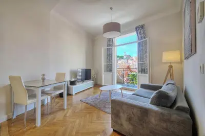 a living room with a couch and a table at IMMOGROOM - Palais des festivals within walking distance - balcony - wifi - in Cannes