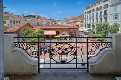 a balcony with a table and a view of a city at IMMOGROOM - Palais des festivals within walking distance - balcony - wifi - in Cannes