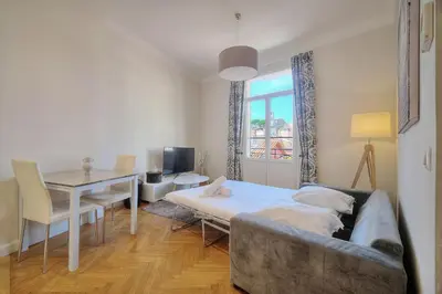 a living room with a couch and a table at IMMOGROOM - Palais des festivals within walking distance - balcony - wifi - in Cannes