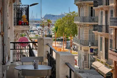 a table on a balcony with a view of a city at IMMOGROOM - Palais des festivals within walking distance - balcony - wifi - in Cannes