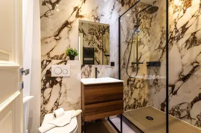 a bathroom with a shower and a sink at croisette appartement 3 chambres The Six in Cannes