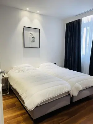 a large bed in a bedroom with a window at croisette appartement 3 chambres The Six in Cannes