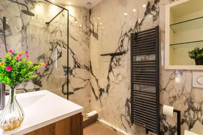 a bathroom with a shower and a white sink at croisette appartement 3 chambres The Six in Cannes