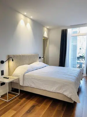 a bedroom with a large bed and a window at croisette appartement 3 chambres The Six in Cannes