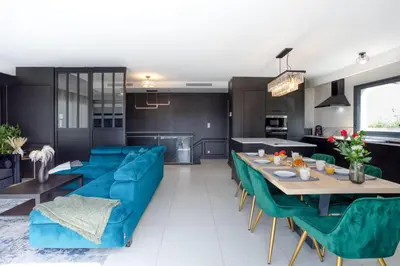 a living room with a blue couch and a table at Villa modern Super-Cannes heated Pool, Parking, CLIM, 7 min to Cannes Beach in Vallauris
