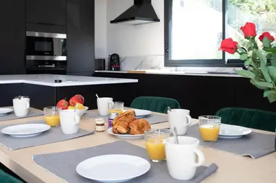 a table with plates of food and glasses of orange juice at Villa modern Super-Cannes heated Pool, Parking, CLIM, 7 min to Cannes Beach in Vallauris