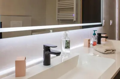 a bathroom sink with a faucet and a mirror at Villa modern Super-Cannes heated Pool, Parking, CLIM, 7 min to Cannes Beach in Vallauris