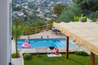 a swimming pool with a deck and a pink flamingo at Villa modern Super-Cannes heated Pool, Parking, CLIM, 7 min to Cannes Beach in Vallauris