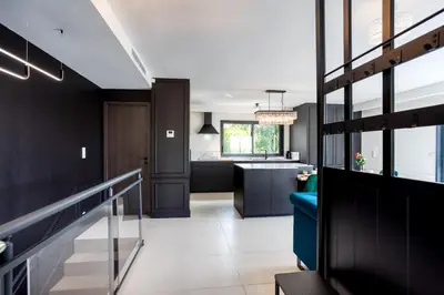 an open kitchen and living room with black walls at Villa modern Super-Cannes heated Pool, Parking, CLIM, 7 min to Cannes Beach in Vallauris