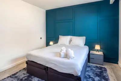 a bedroom with a large bed with two teddy bears on it at Villa modern Super-Cannes heated Pool, Parking, CLIM, 7 min to Cannes Beach in Vallauris