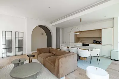 a living room with a couch and a table at Superbe appartement 120m2 au coeur de Cannes in Cannes