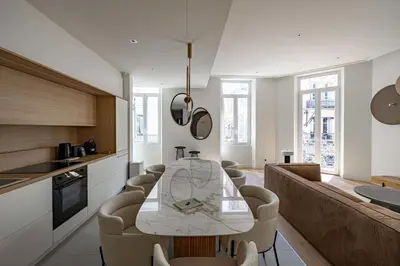 a kitchen and dining room with a table and chairs at Superbe appartement 120m2 au coeur de Cannes in Cannes