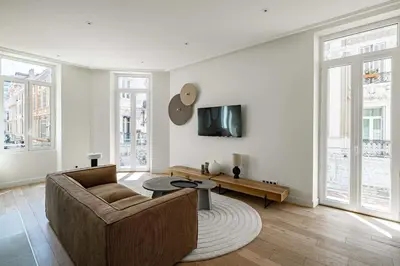 a living room with a couch and a table at Superbe appartement 120m2 au coeur de Cannes in Cannes
