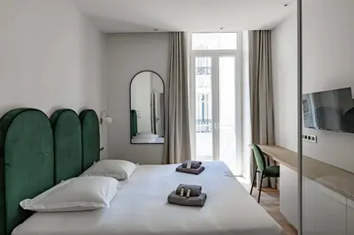 a bedroom with a bed with two towels on it at Superbe appartement 120m2 au coeur de Cannes in Cannes