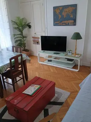 a living room with a flat screen tv on a table at Cannes Holidays - Charmant, authentique, 3 Chambres, calme, Palais & Plage in Cannes