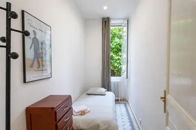 a small room with a bed and a window at Cannes Holidays - Charmant, authentique, 3 Chambres, calme, Palais & Plage in Cannes