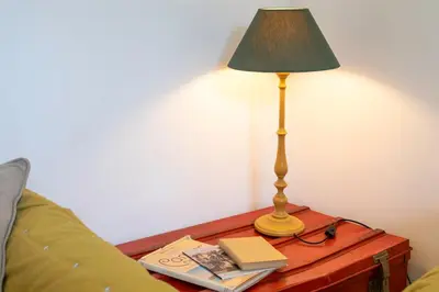 a lamp sitting on a table next to a bed at Cannes Holidays - Charmant, authentique, 3 Chambres, calme, Palais & Plage in Cannes