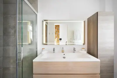 a bathroom with a sink and a glass shower at Super Central, Spacious, Sunny Large Deck & SPA in Cannes