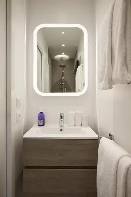 a bathroom with a sink and a mirror at Super Central, Spacious, Sunny Large Deck & SPA in Cannes