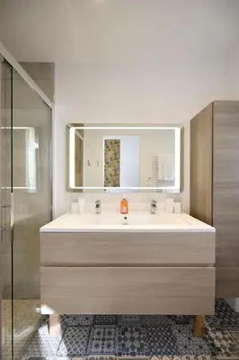 a bathroom with a large sink and a shower at Super Central, Spacious, Sunny Large Deck & SPA in Cannes
