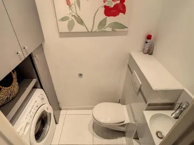 a small bathroom with a toilet and a washing machine at Quality 1 bedroom rue du Canada 5 mins Croisette 208 in Cannes