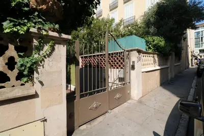a gate on a sidewalk next to a street at Quality 1 bedroom rue du Canada 5 mins Croisette 208 in Cannes