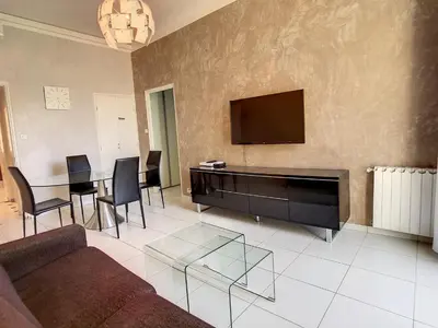 a living room with a couch and a flat screen tv at Quality 1 bedroom rue du Canada 5 mins Croisette 208 in Cannes