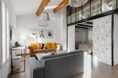 a living room with a couch and a loft at Loft Meynadier by Halldis in Cannes