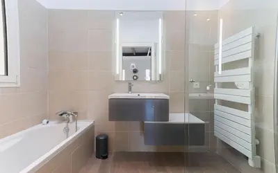 a bathroom with a sink and a bath tub at Loft Meynadier by Halldis in Cannes