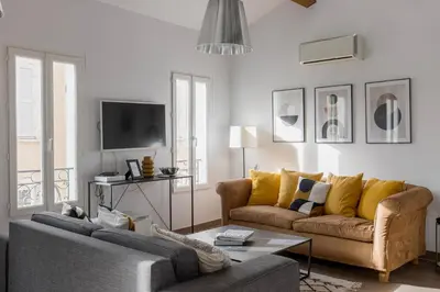a living room with two couches and a tv at Loft Meynadier by Halldis in Cannes