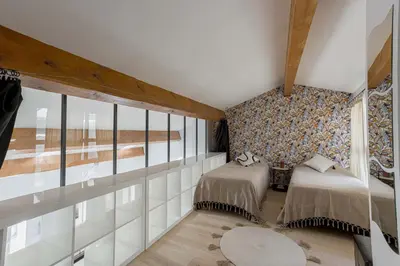 a bedroom with two beds and a wall of windows at Loft Meynadier by Halldis in Cannes