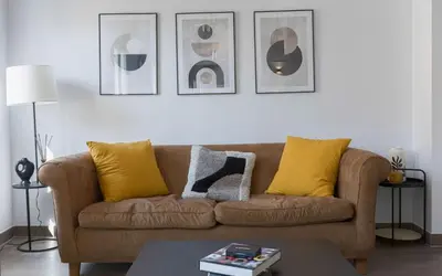 a living room with a brown couch with yellow pillows at Loft Meynadier by Halldis in Cannes