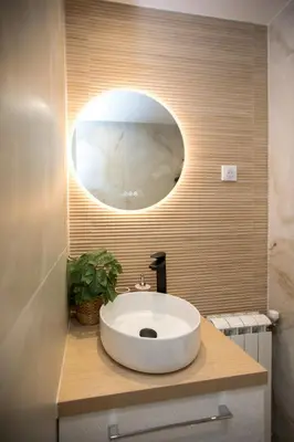 a bathroom with a white sink and a mirror at Jungle Room Jacuzzi Privé Évasion en amoureux in Cannes