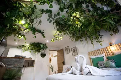 a bedroom with a bed with a swan on it at Jungle Room Jacuzzi Privé Évasion en amoureux in Cannes