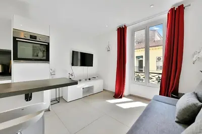 a living room with a couch and a tv at Nice 2 Rooms in the heart of Cannes in Cannes